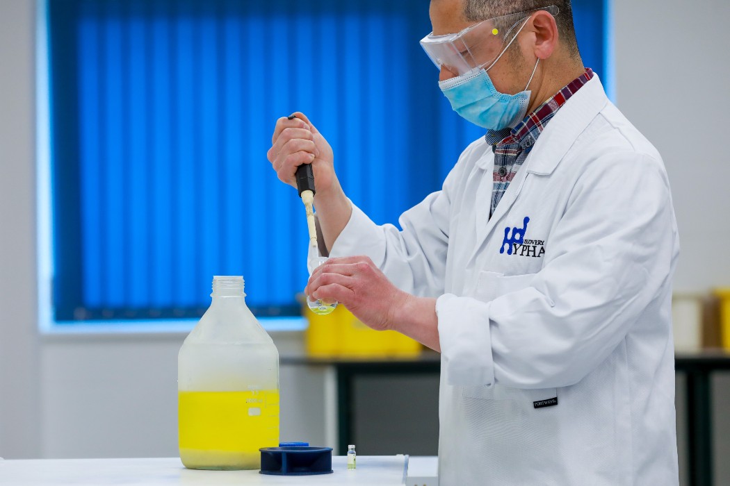 scientist standing whilst doing an expriment
